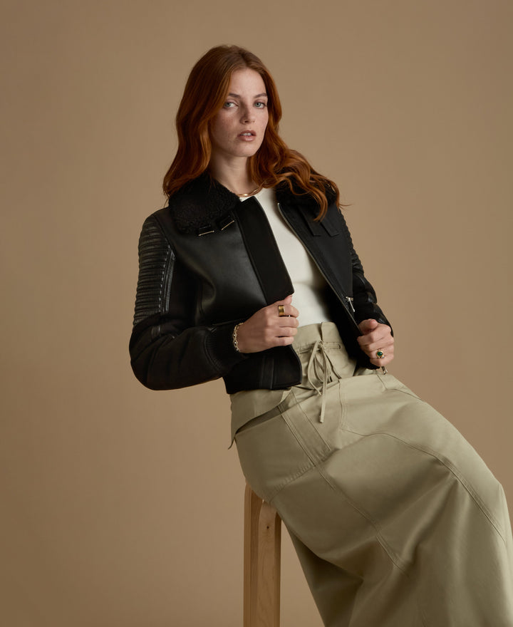 Woman wearing black shearling cropped jacket