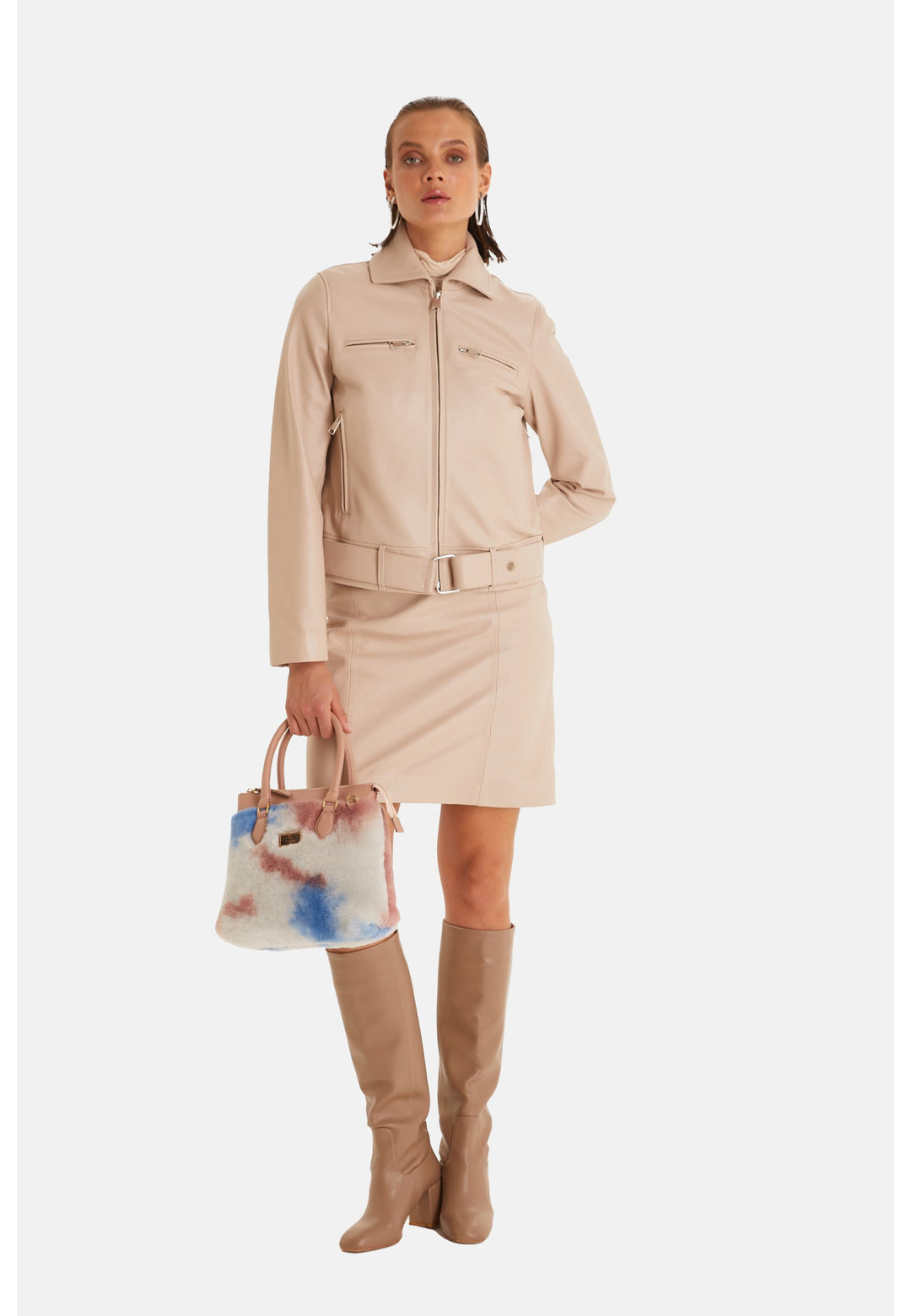 Woman wearing beige leather blazer and skirt