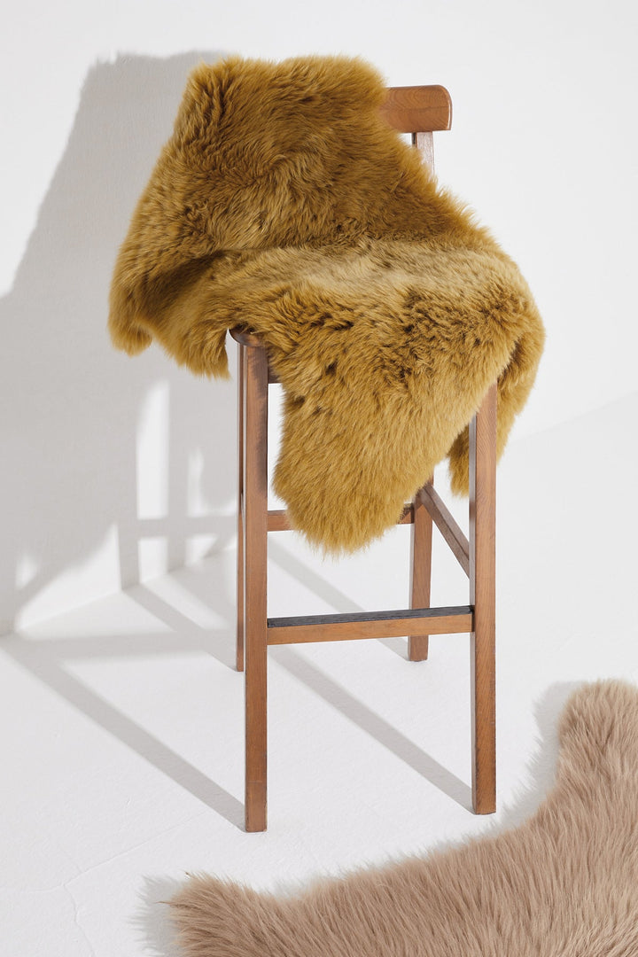 Mustard real sheepskin rug on stool