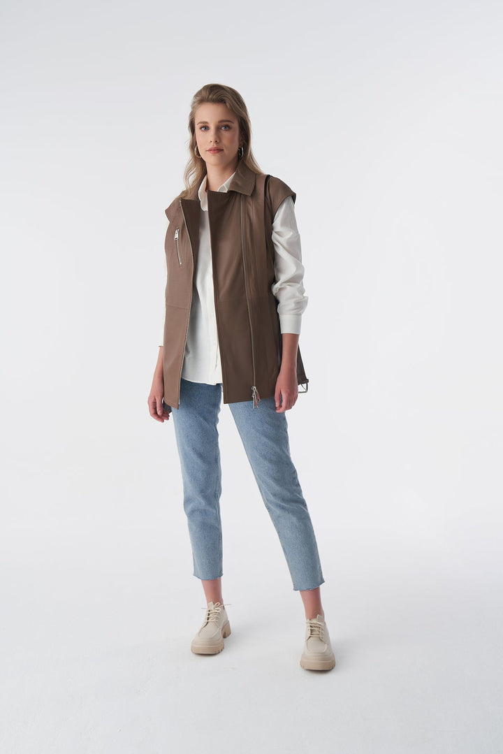 Woman wearing brown leather vest