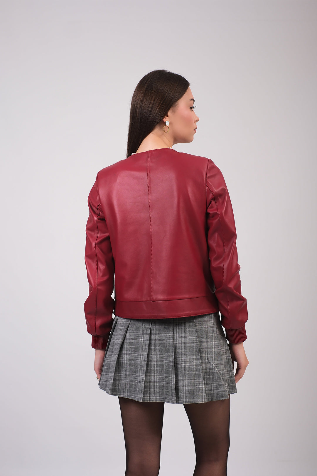Woman wearing red leather jacket - back view