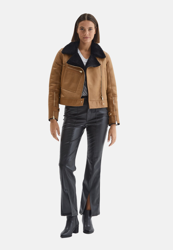 Beige sheepskin biker jacket on model