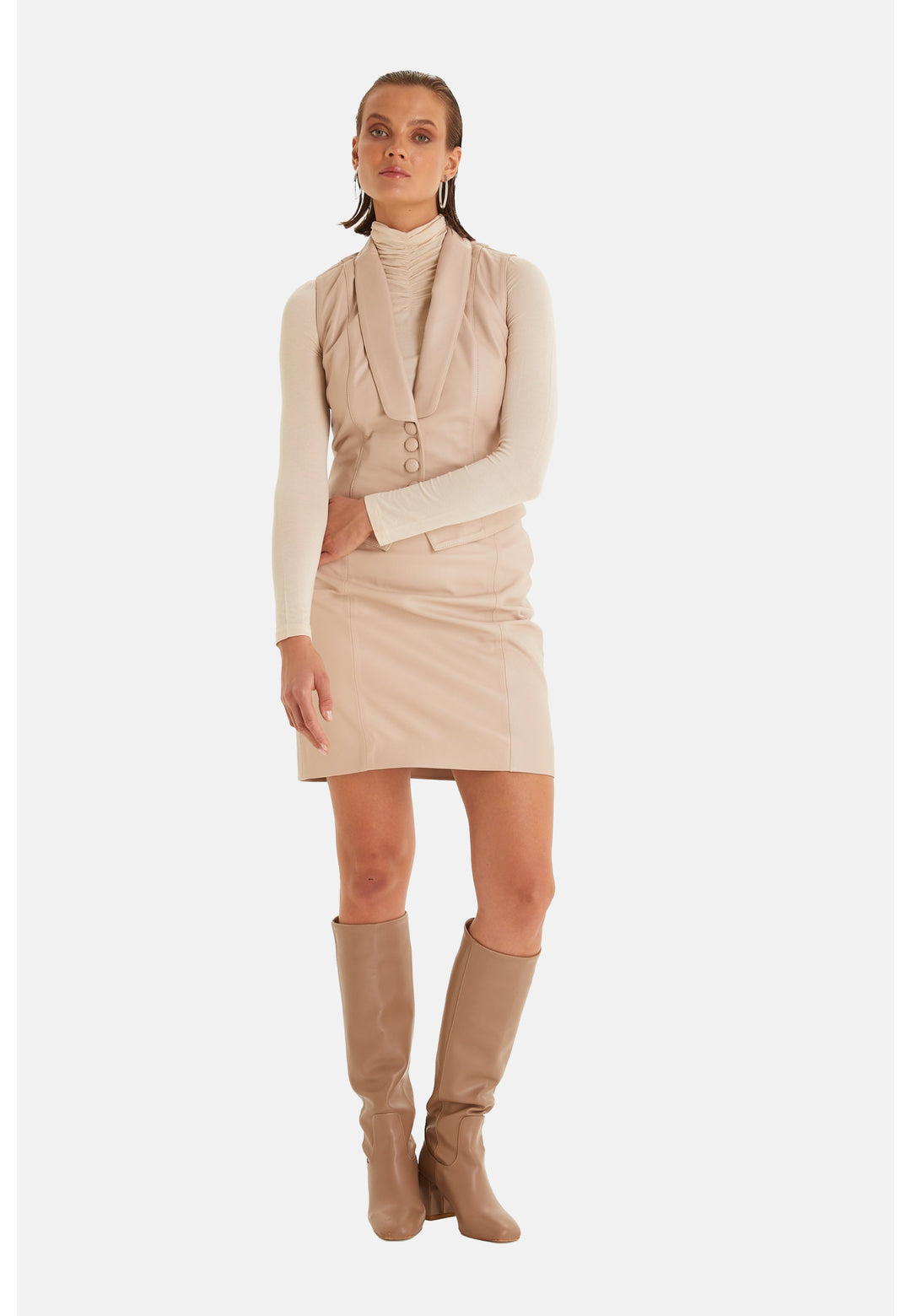 Beige leather vest outfit on model
