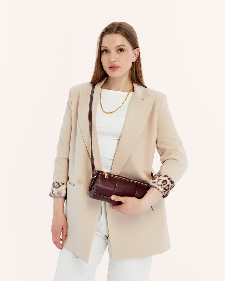 Woman with burgundy woven leather handbag