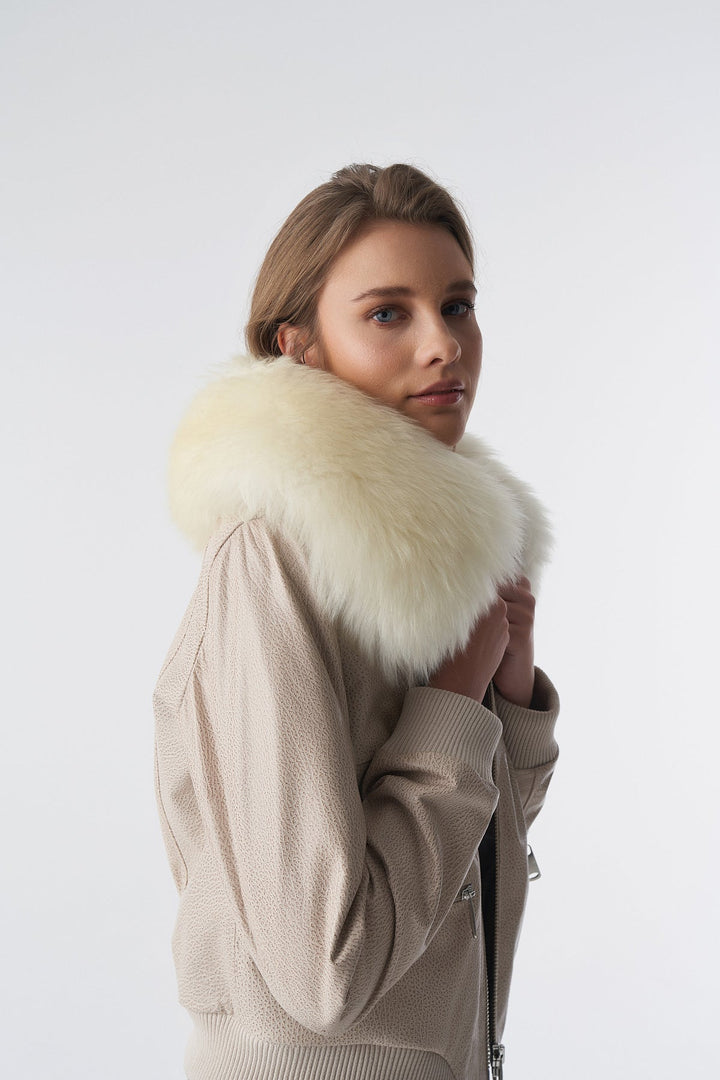 Woman wearing beige bomber jacket with fur