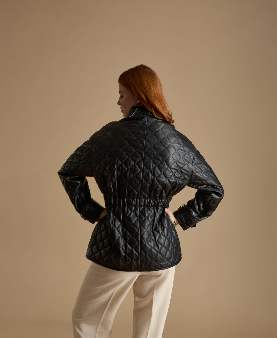 Woman wearing black quilted leather coat