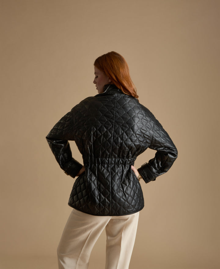 Woman wearing black quilted leather coat