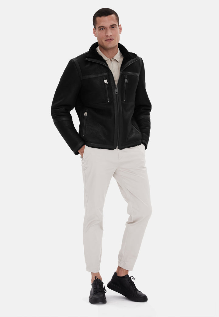 Man wearing black shearling leather jacket