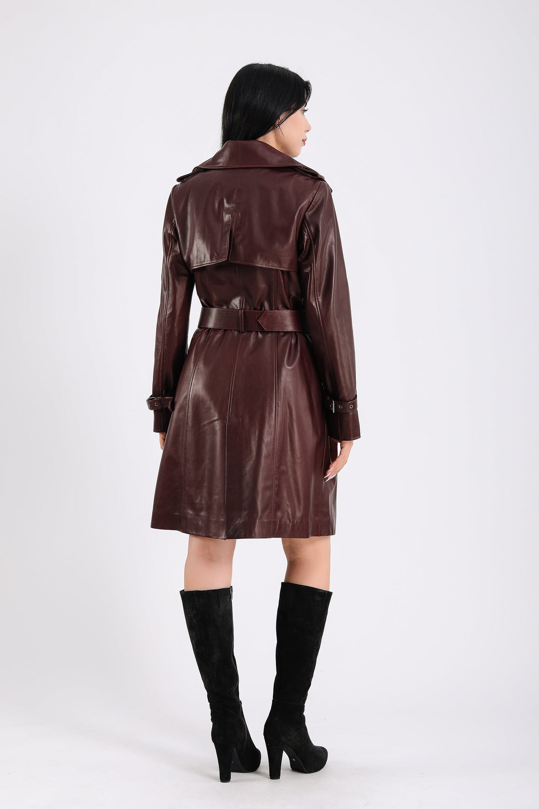 Woman in brown leather trench coat