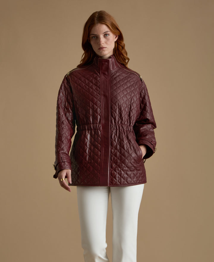 Woman wearing burgundy quilted leather coat