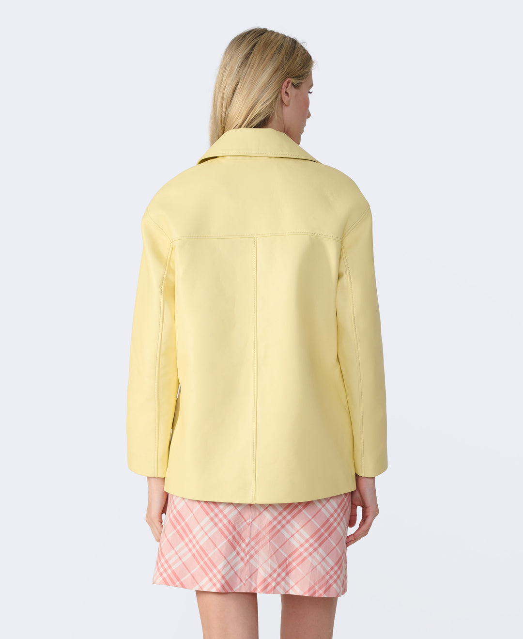 Woman wearing pale yellow jacket