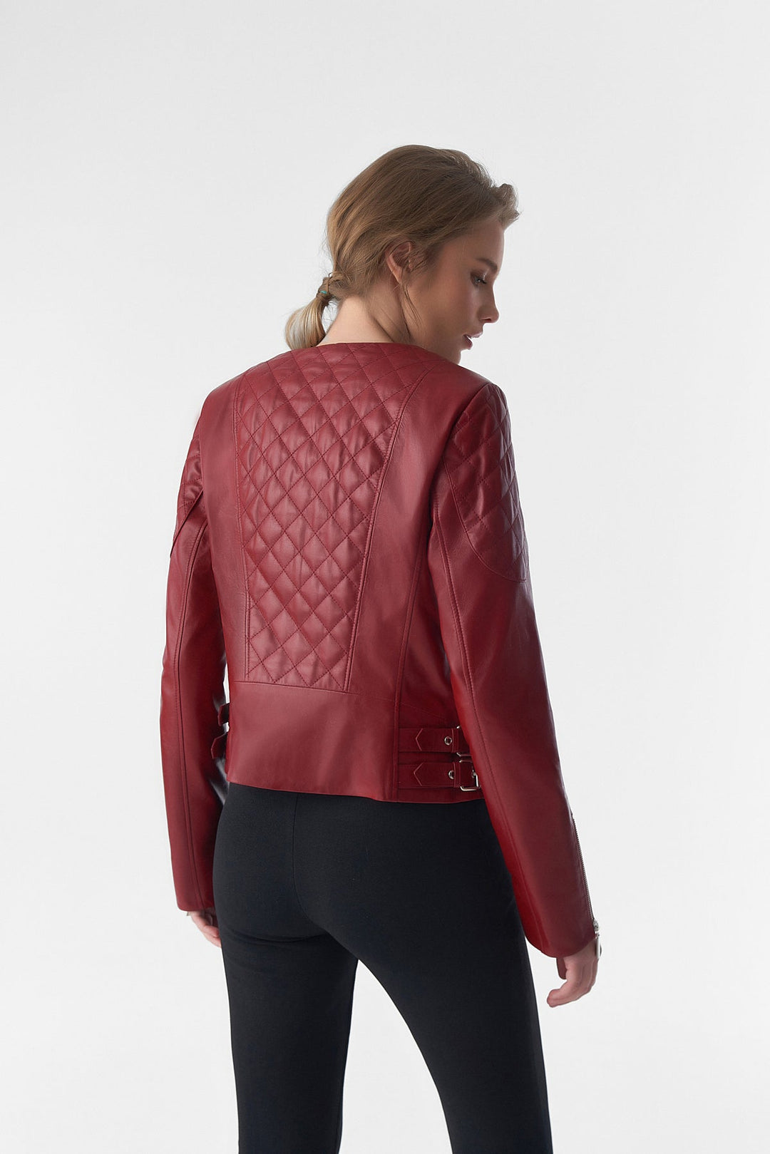 Woman wearing red leather jacket - back view