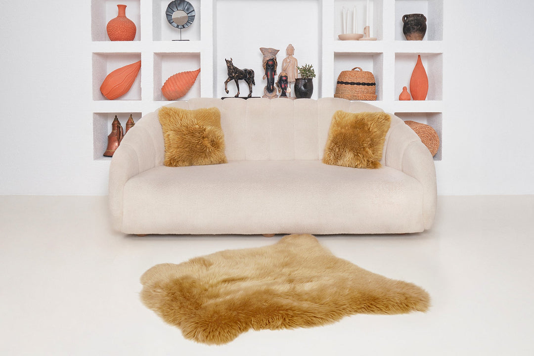 Mustard sheepskin rug on white floor