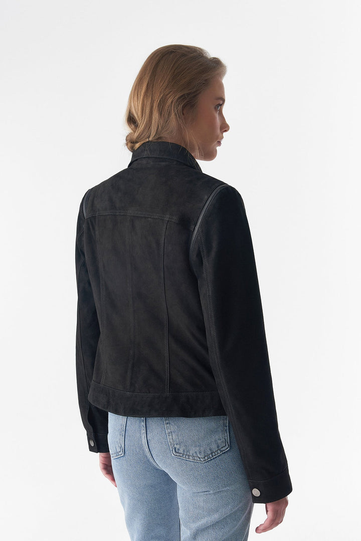 Woman wearing black suede jacket - back view