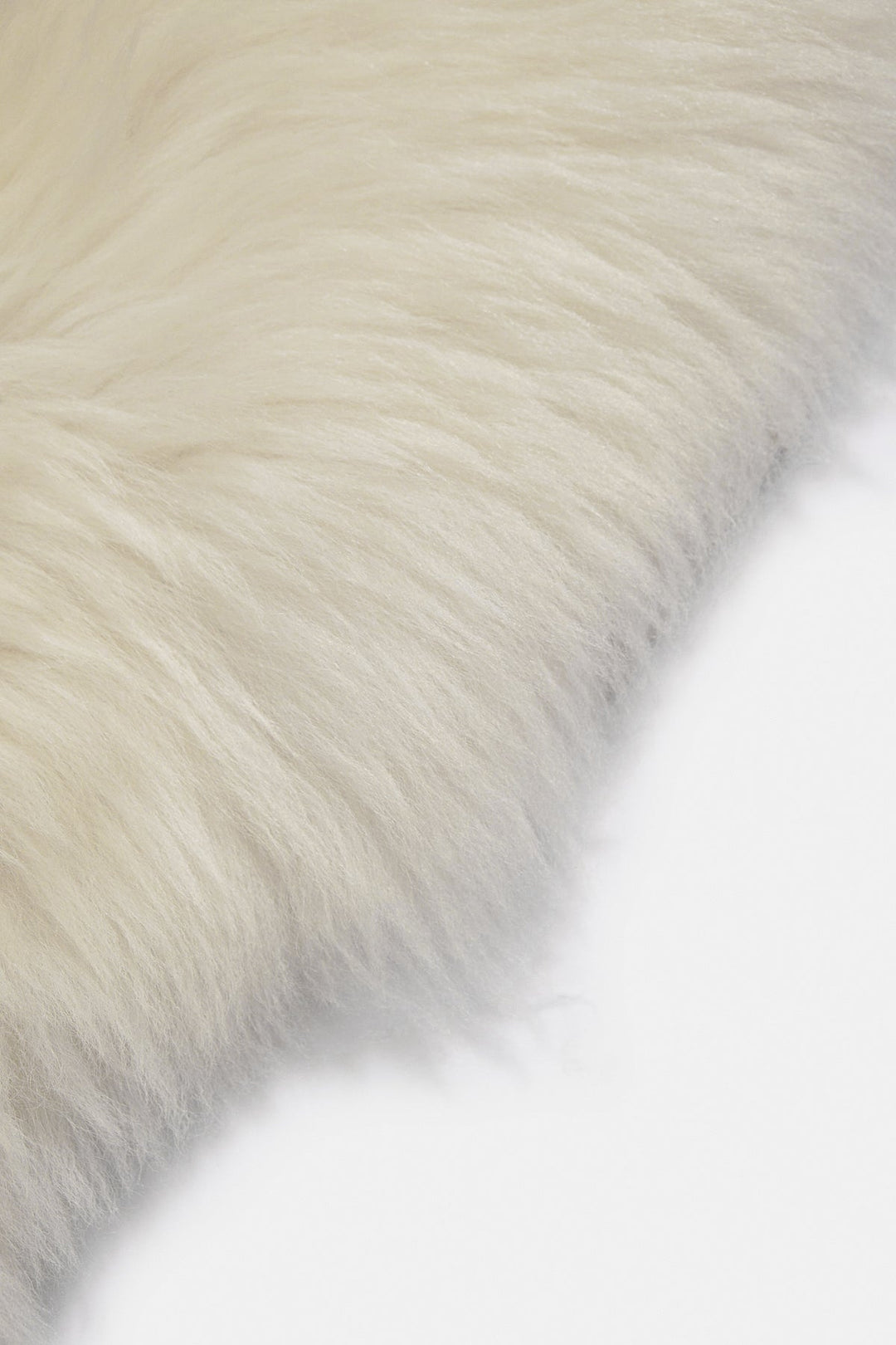 Natural white sheepskin rug corner