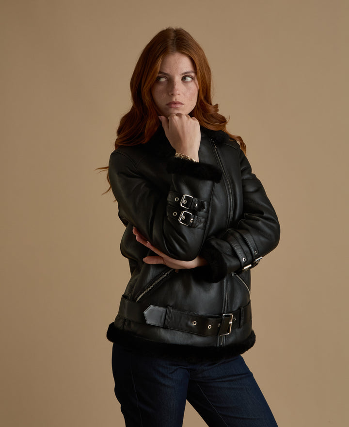 Woman in black shearling jacket