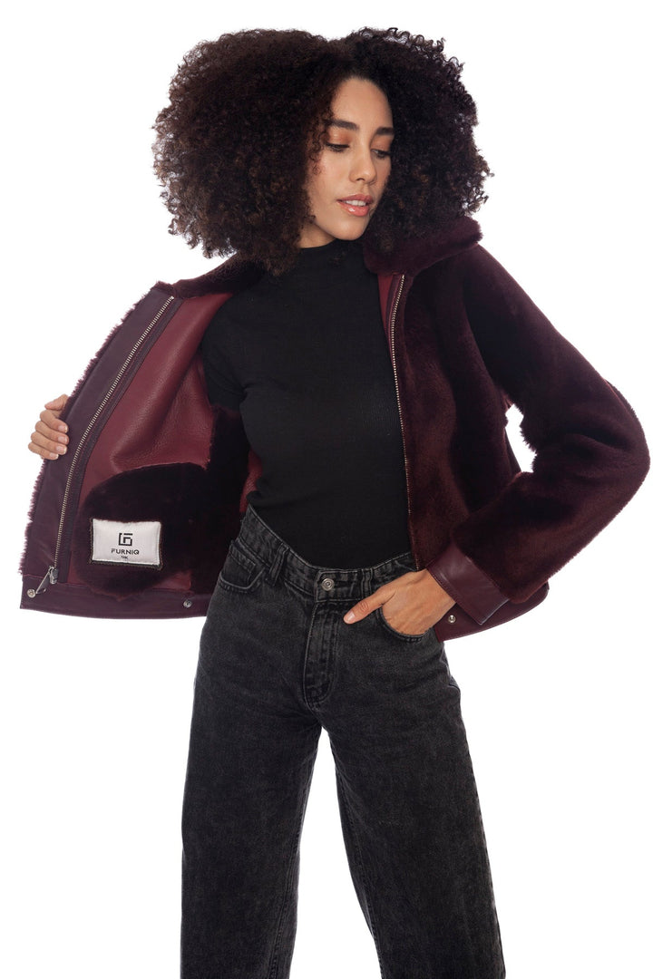 Woman wearing burgundy shearling jacket