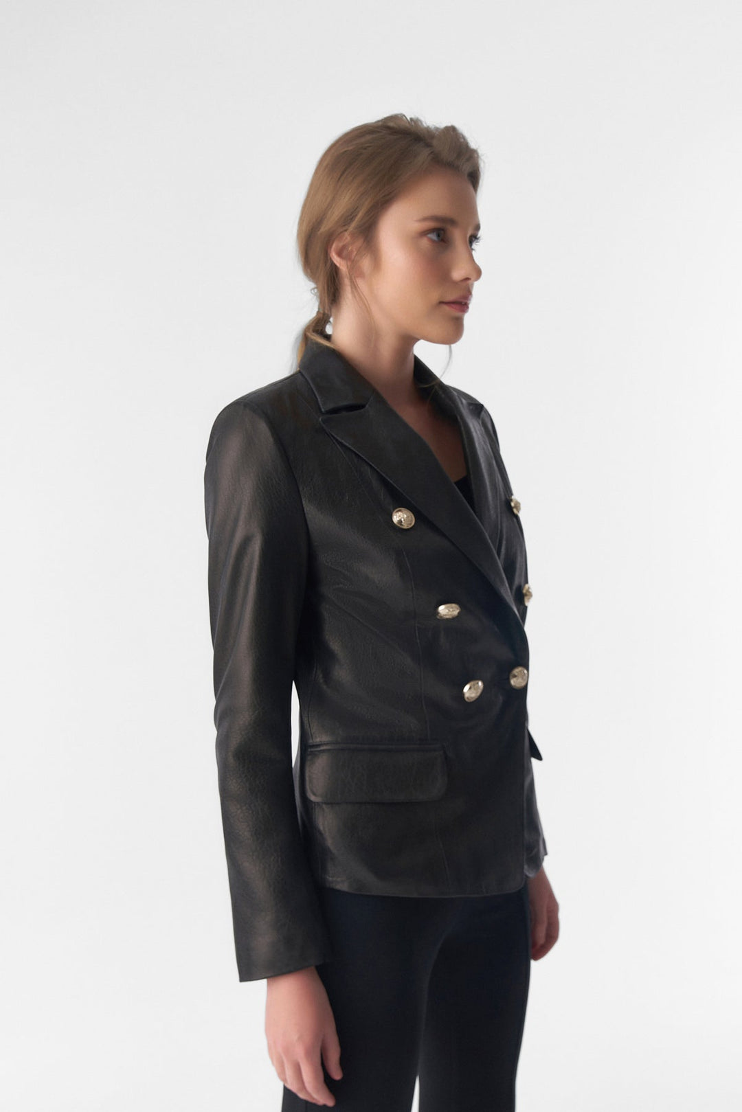 Woman wearing black leather double-breasted blazer