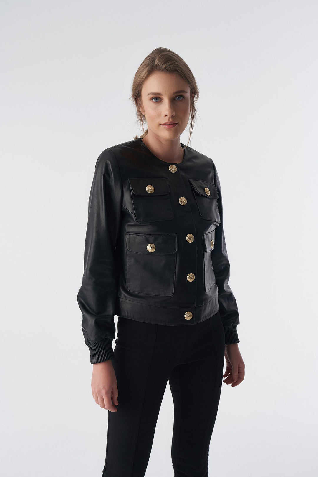 Woman wearing black leather jacket with buttons