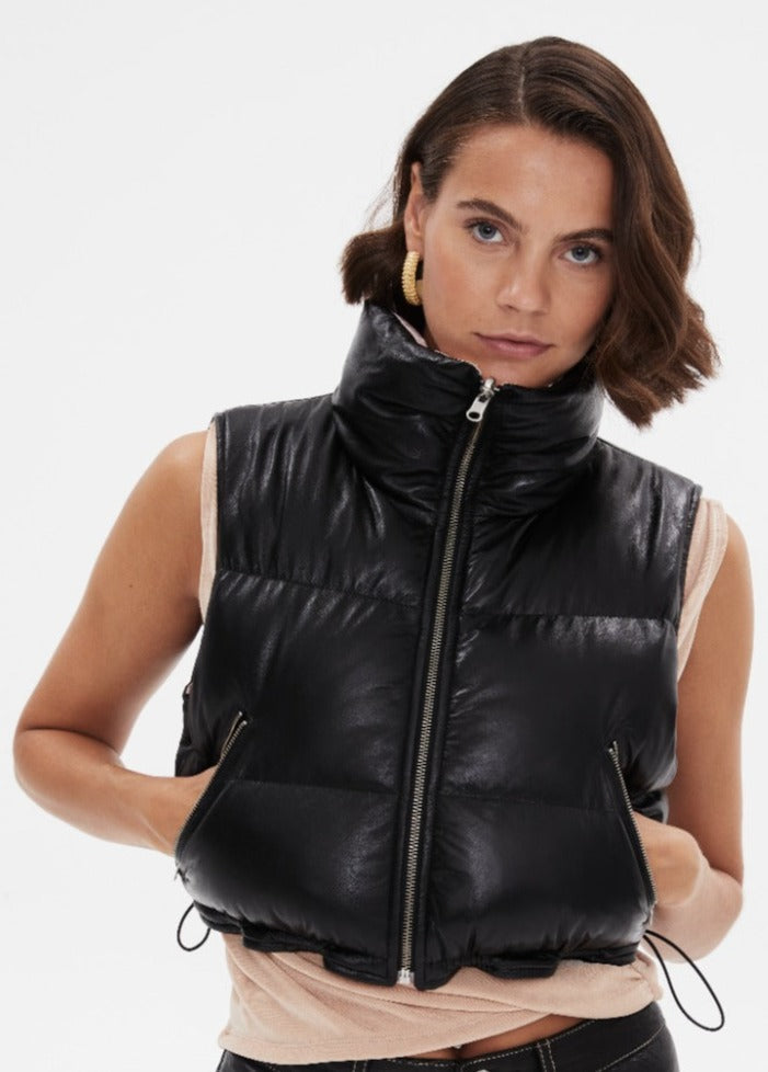 Woman wearing black leather puffer vest