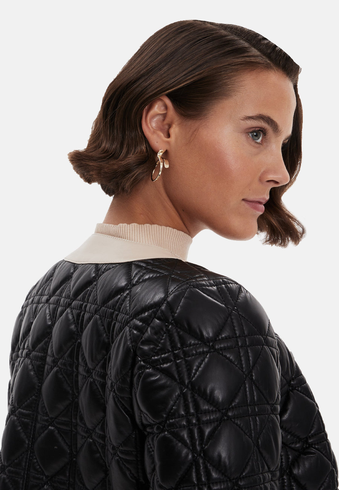 Woman wearing black quilted leather jacket