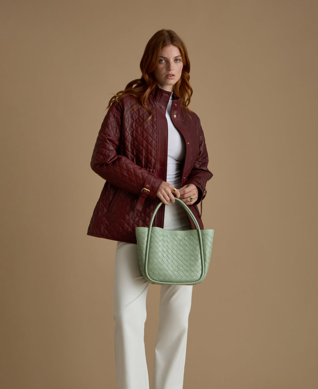 Woman wearing burgundy quilted leather coat