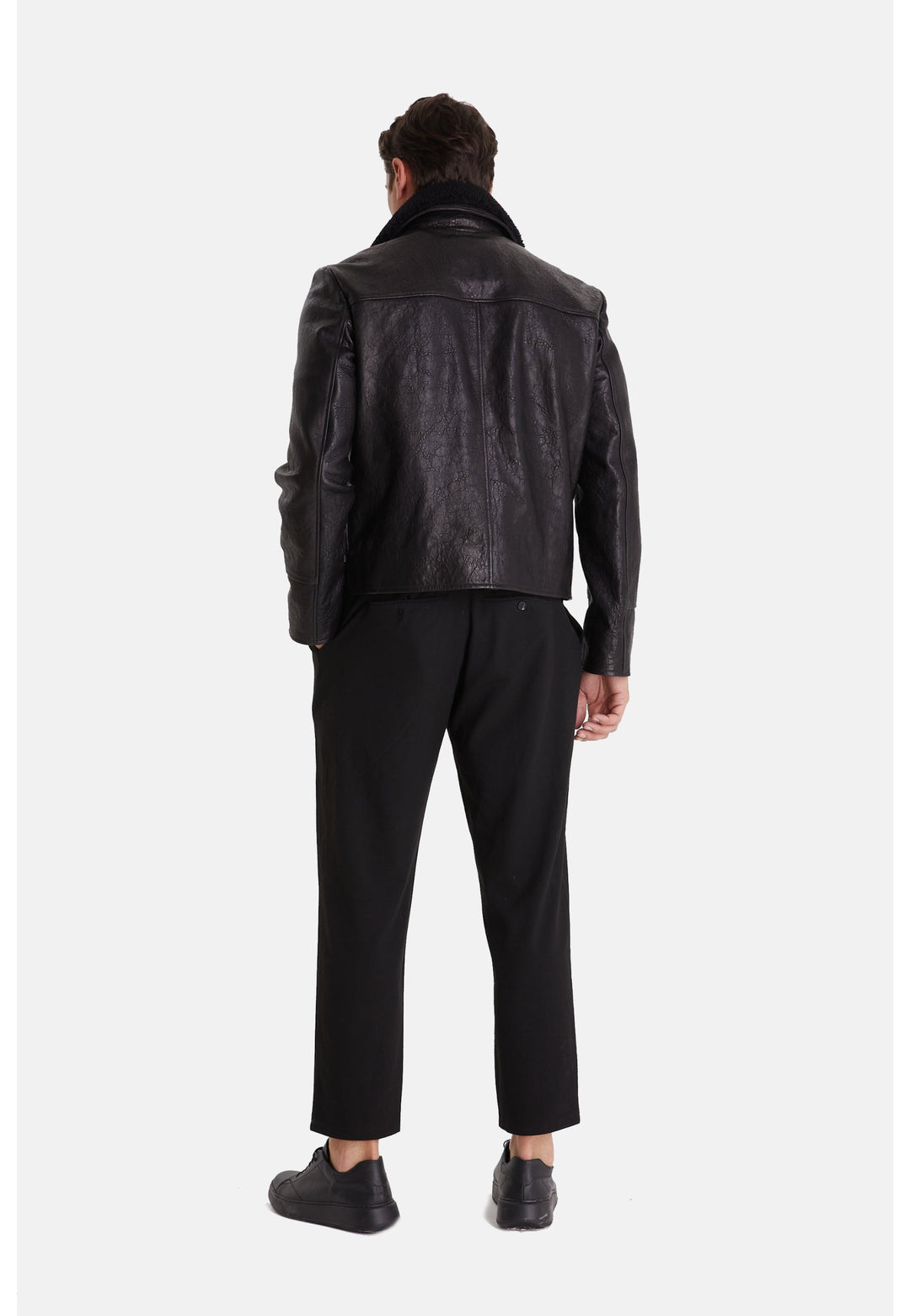 Man wearing black leather jacket back view
