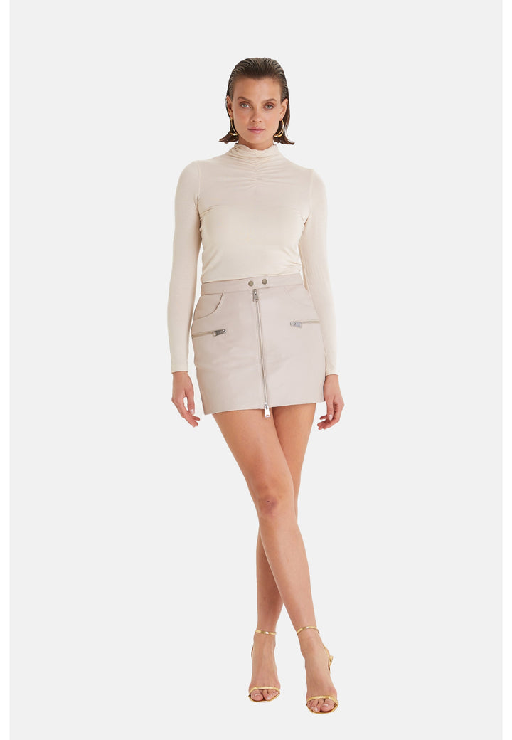 Woman modeling beige leather mini skirt
