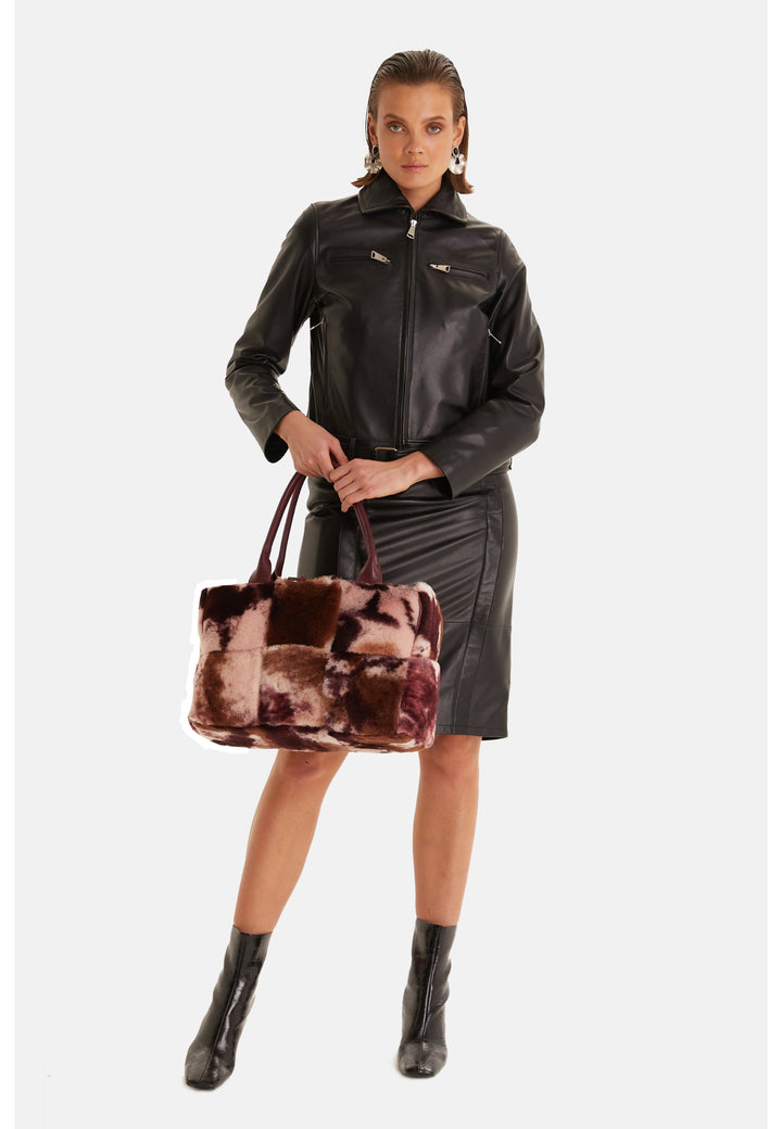 Woman wearing black leather jacket and skirt