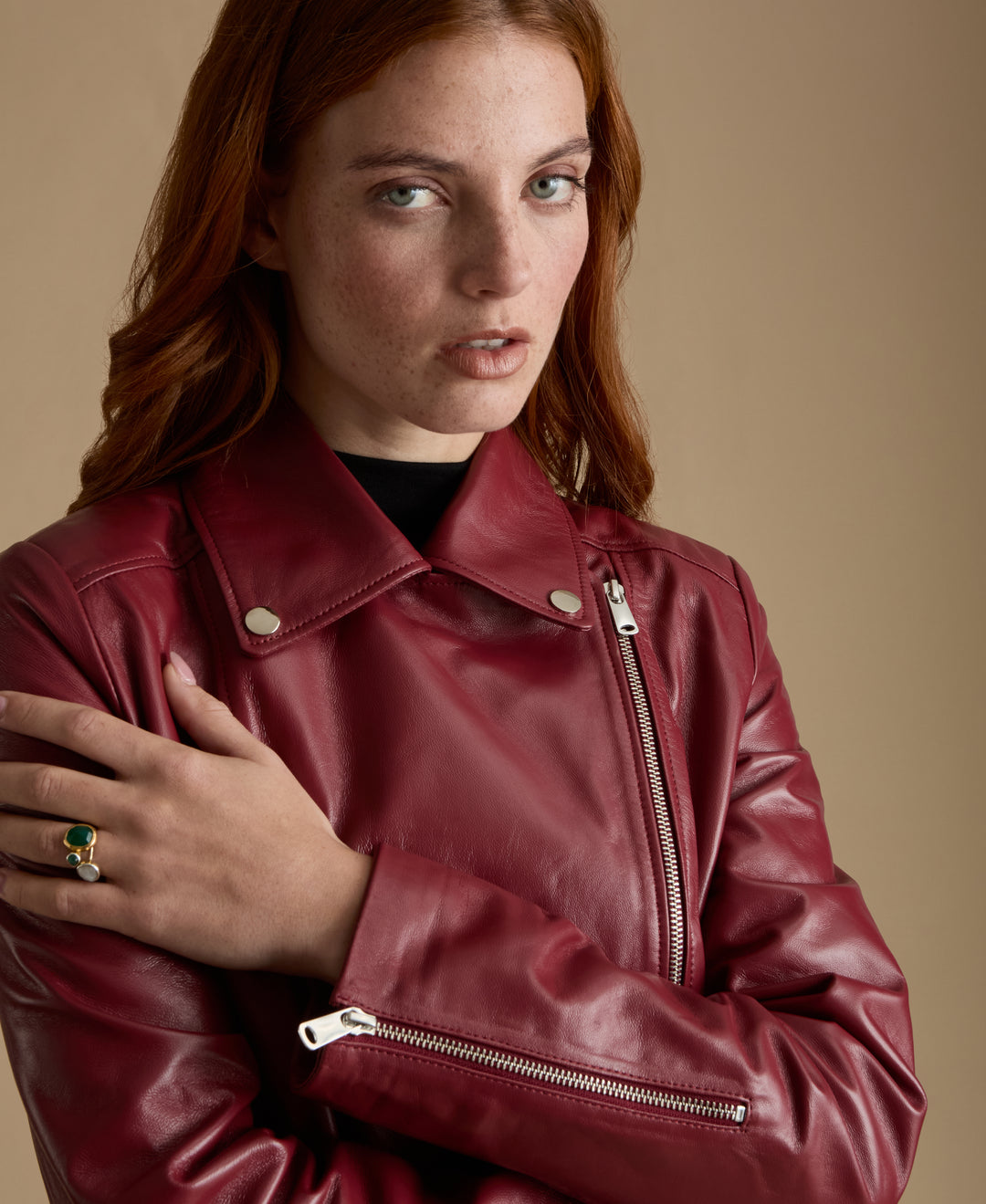 Close-up of light burgundy nappa leather jacket with silver zipper and premium British leather texture