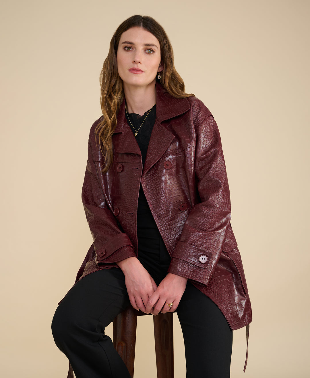 Women’s burgundy leather trench coat styled for elevated city wear – croc embossed finish