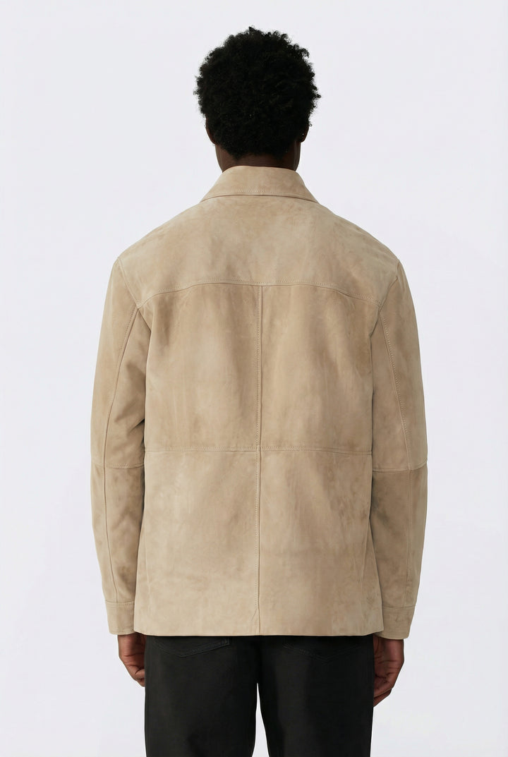 Person wearing a beige suede jacket on a white background showing back of jacket