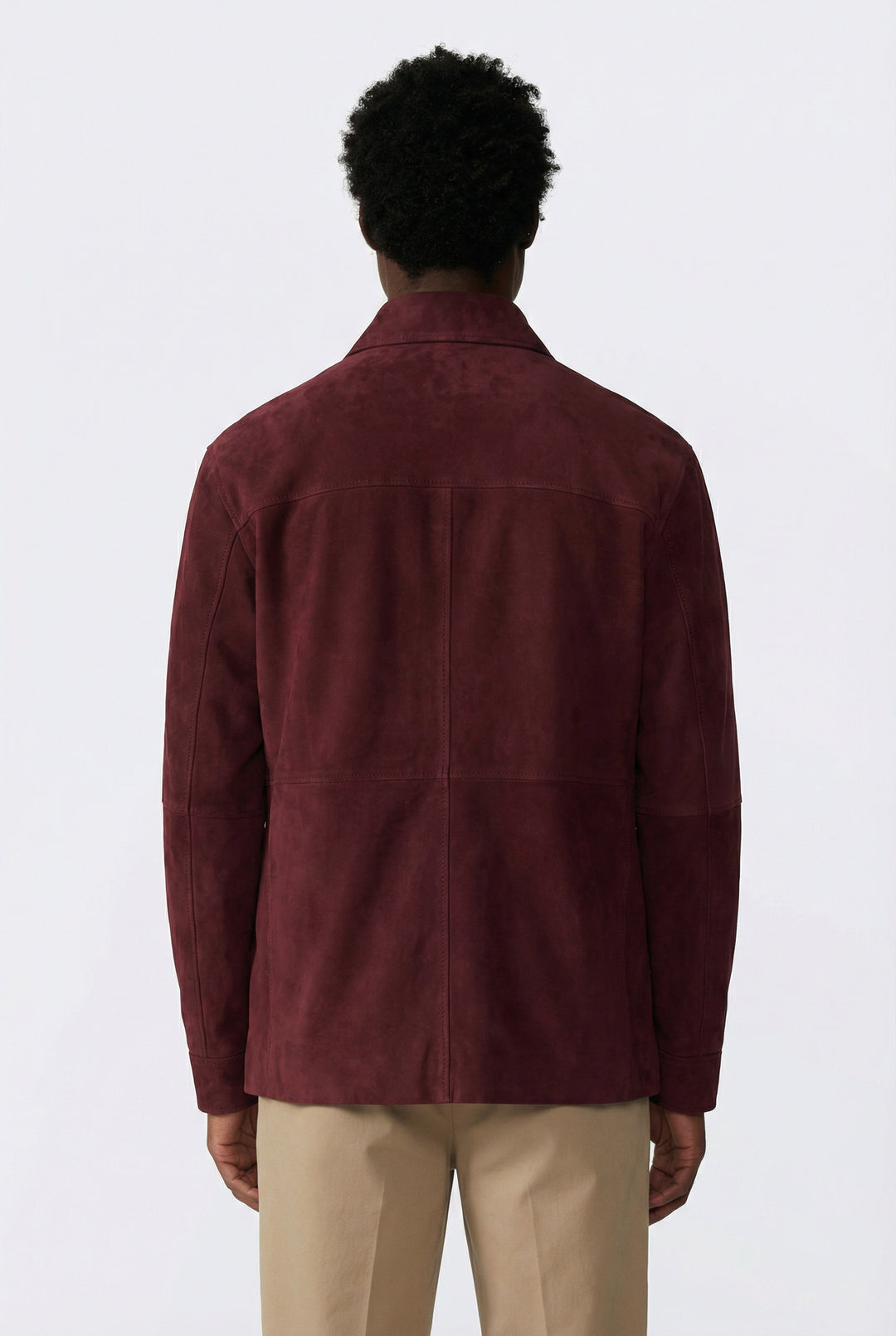Person wearing a burgundy jacket on a white background