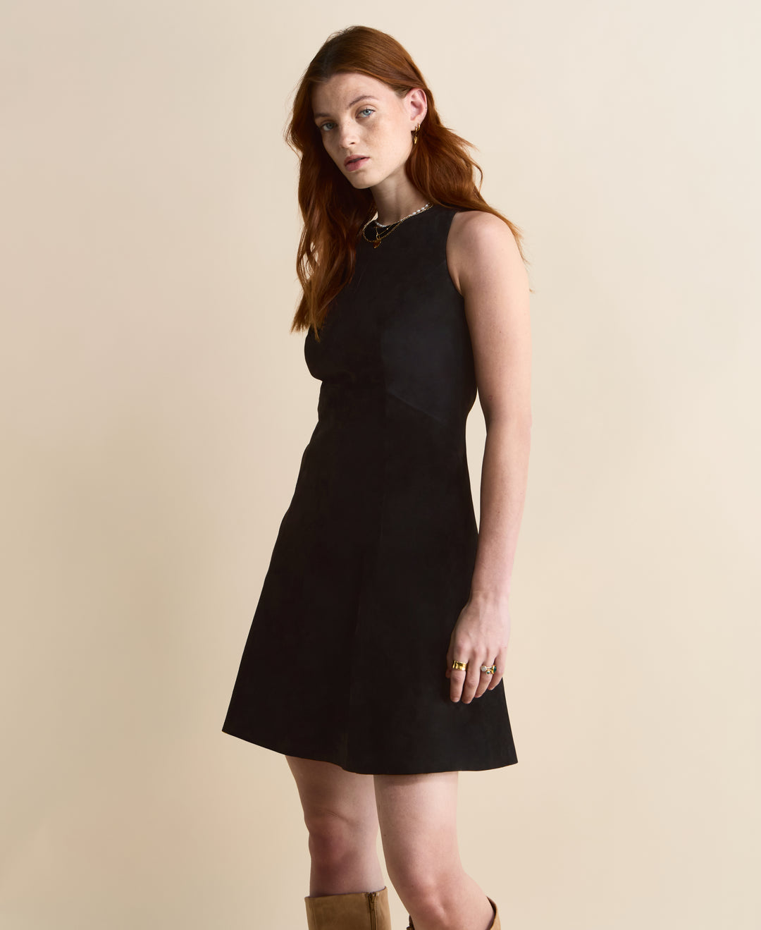 Side view of black suede A-line dress – modern sleeveless silhouette
