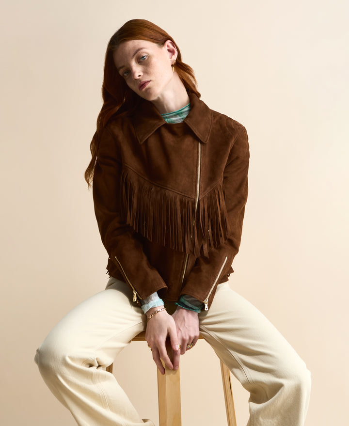 Women’s cropped brown suede jacket styled with neutral trousers