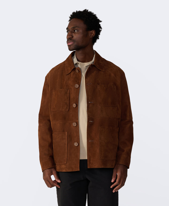 Man wearing a brown suede jacket on a white background