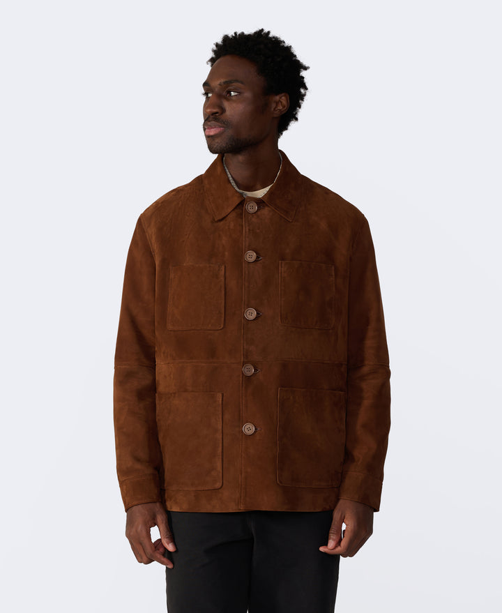 Man wearing a brown suede jacket on a white background