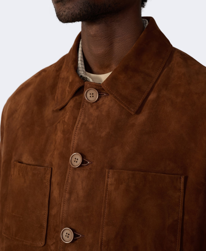 Brown suede jacket with button details on a neutral background
