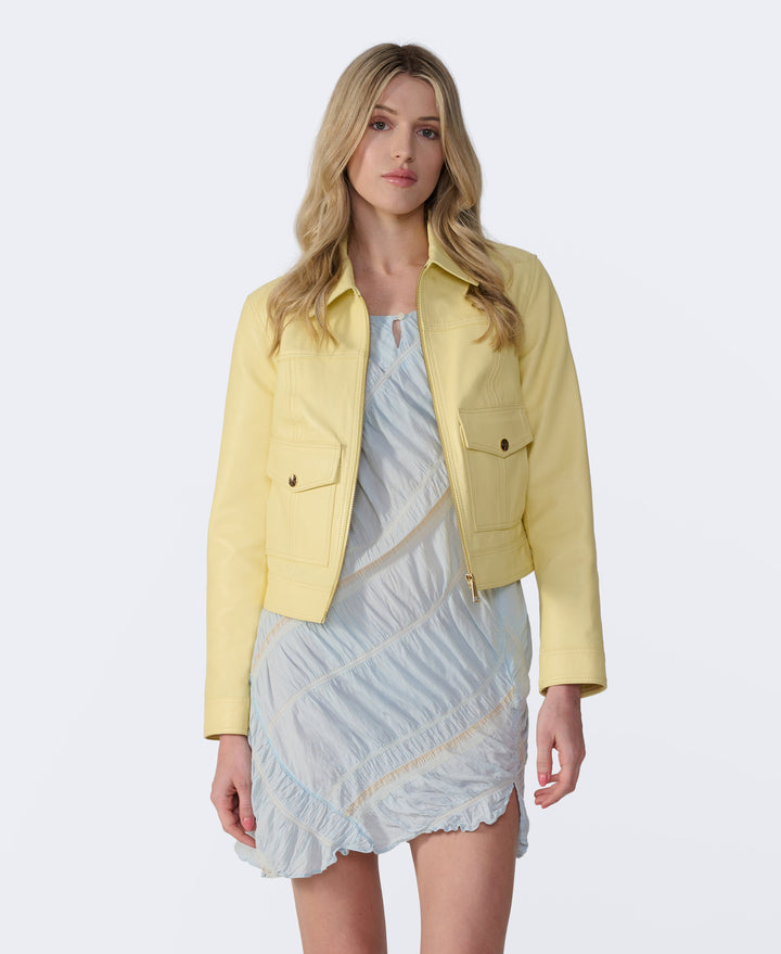Woman wearing yellow leather cropped jacket