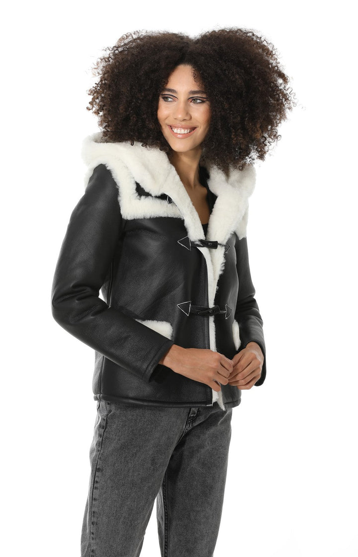 Woman wearing black sheepskin jacket with hood