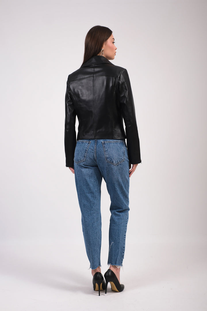 Woman wearing black leather jacket - back