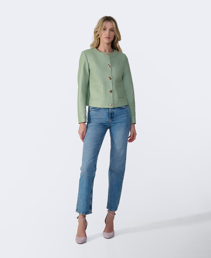 Woman wearing mint green leather jacket
