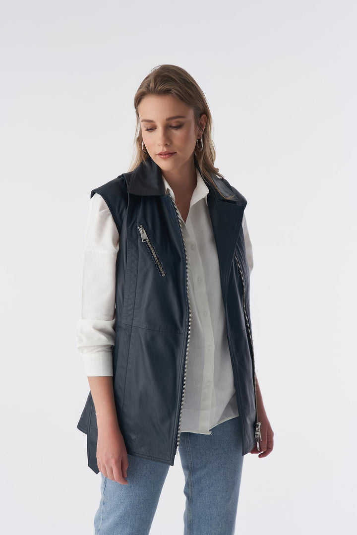 Woman wearing navy leather zip vest