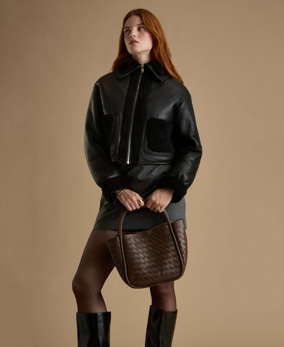 Woman wearing black shearling leather jacket