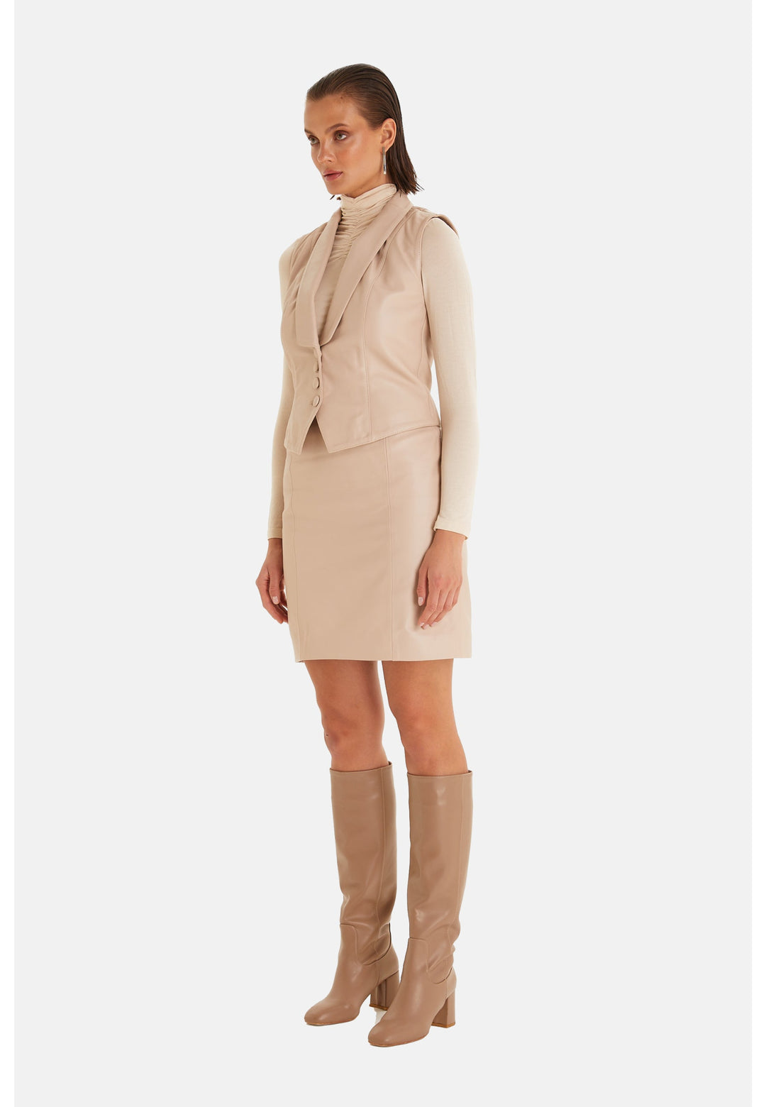 Woman wearing beige leather vest outfit
