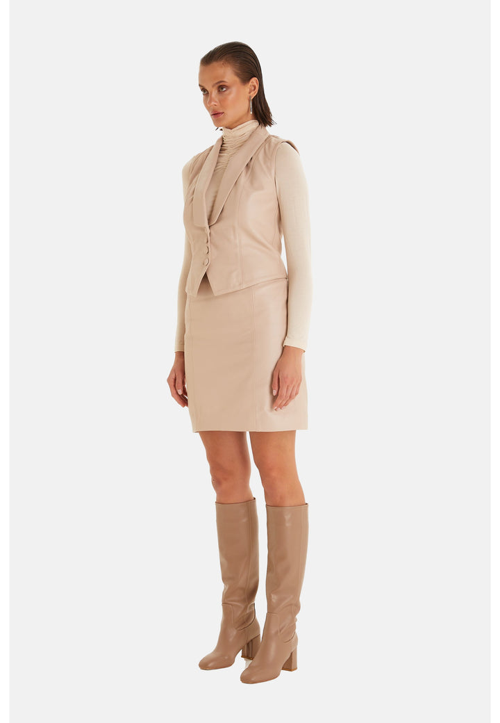 Woman wearing beige leather vest outfit