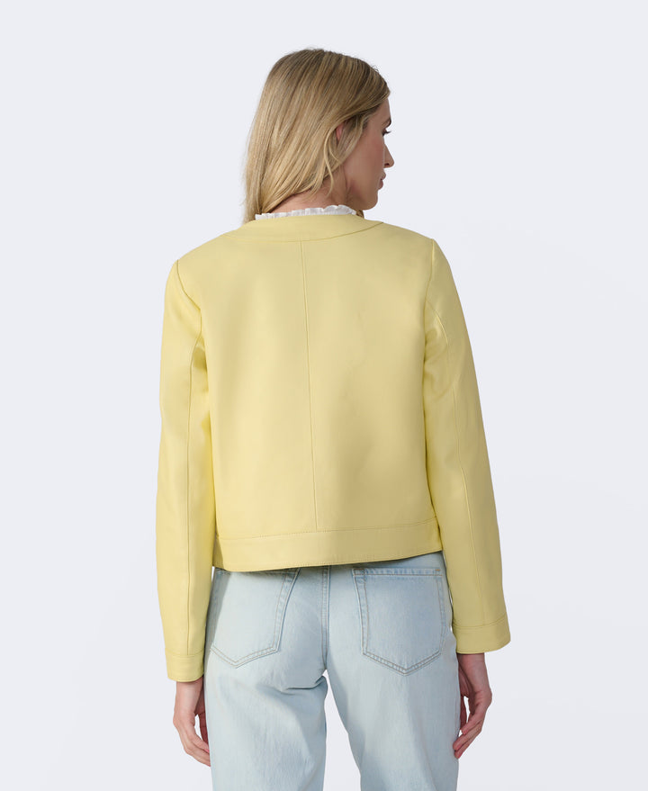 Woman wearing yellow leather jacket back