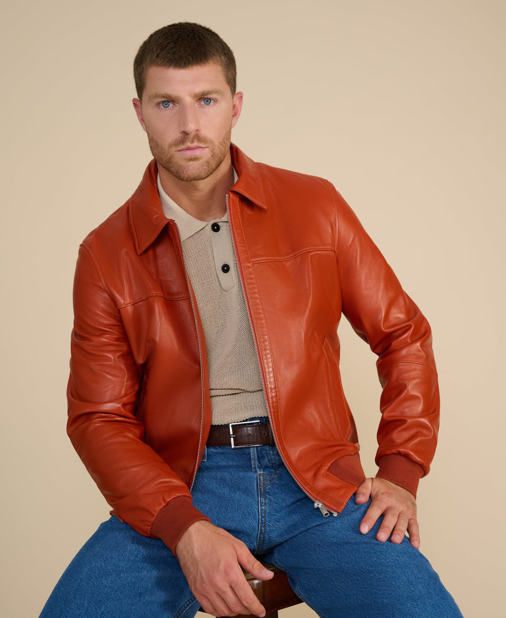 Tan leather bomber jacket on model