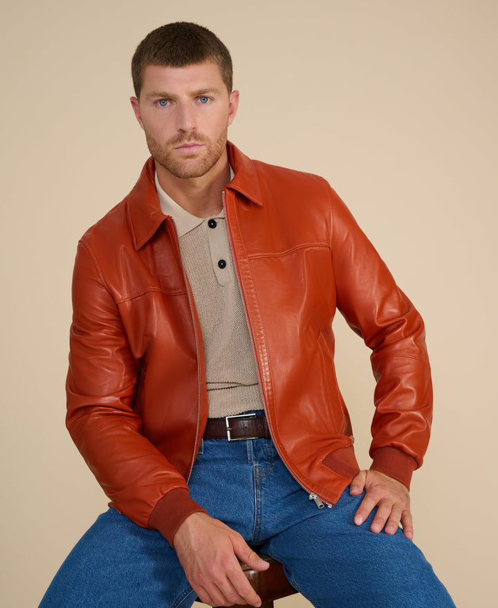Tan leather bomber jacket on model