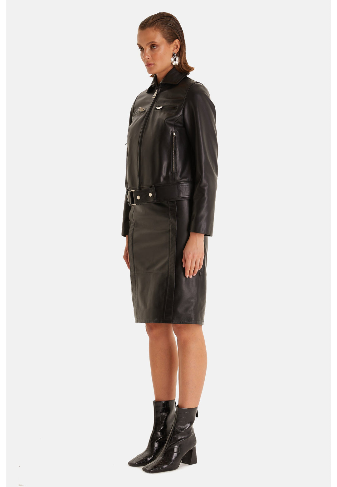 Woman wearing black leather jacket and skirt